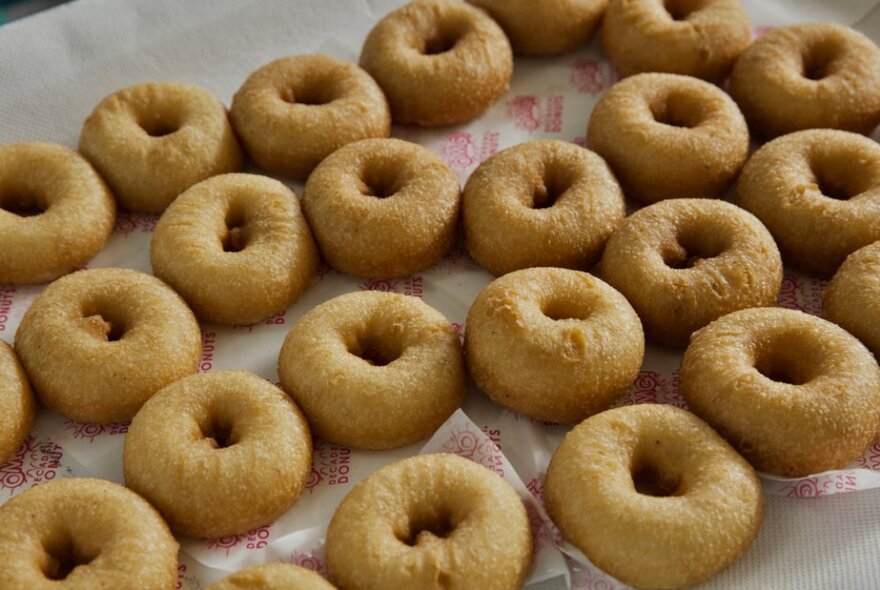 A tray of cinnamon ring style donuts.