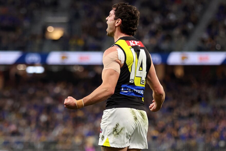 A Richmond football club player celebrates on the field. 
