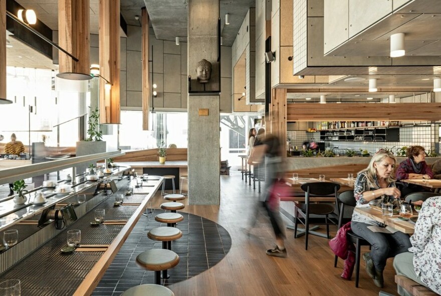 Spacious restaurant with row of bar stools.