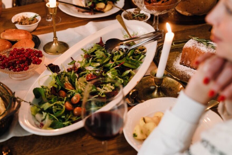 A dining table laden with platters of food of a Christmas festive nature.