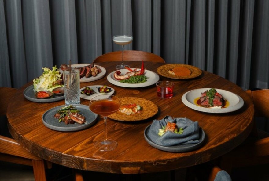 A table set with dishes and cocktails.