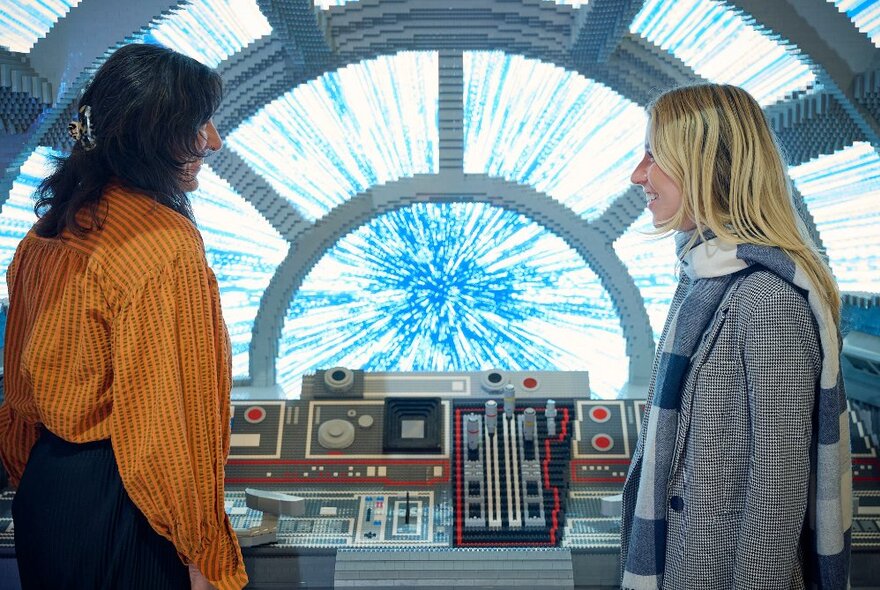 Two people looking at a display as part of the Lego Star Wars exhibition at Melbourne Museum.