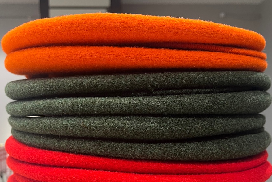 A stack of coloured French berets. 