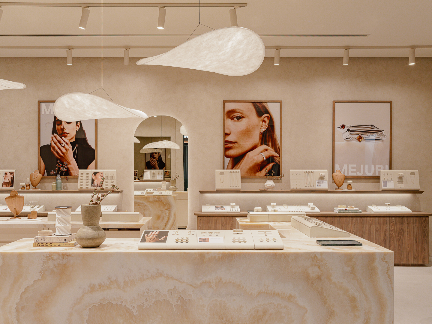 A jewellery store with mirrors and pendant lights.