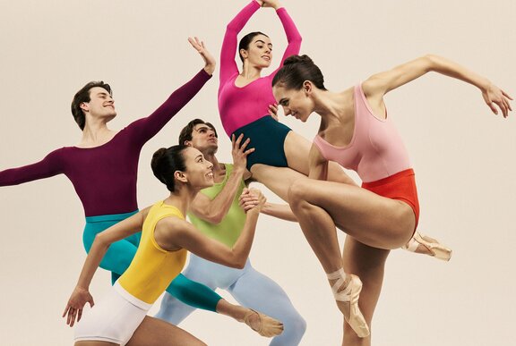 Dancers in different coloured leotards in different dance poses. .