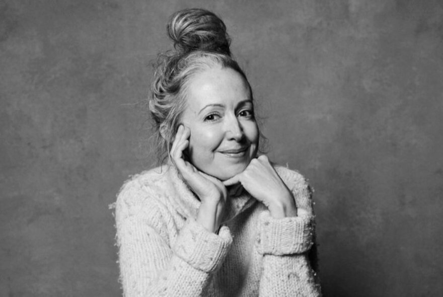 Marieke Hardy, her hair piled on top of her head, wearing a woolly jumper.