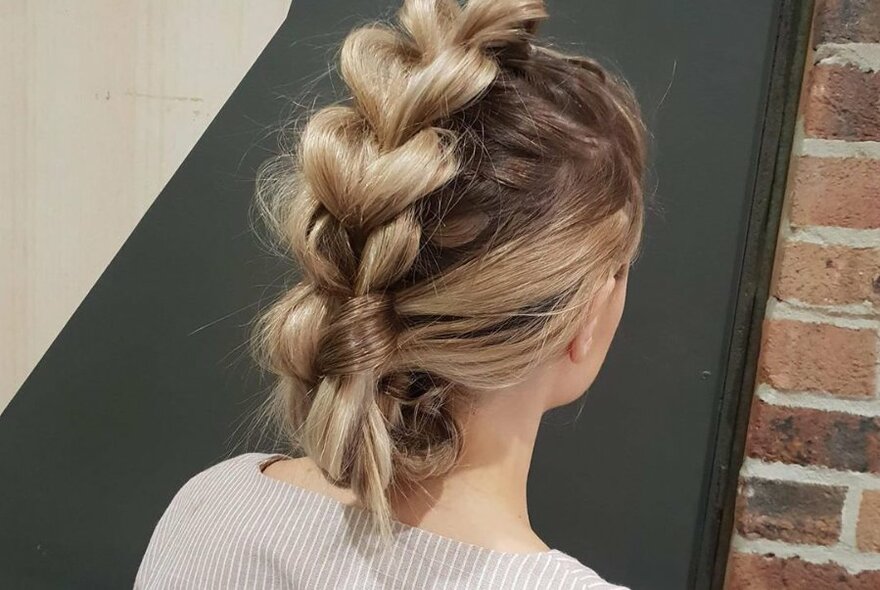 Woman with plaited hair at Roi Hair and Beauty salon.