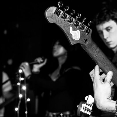 Black and white photograph of band members on stage.
