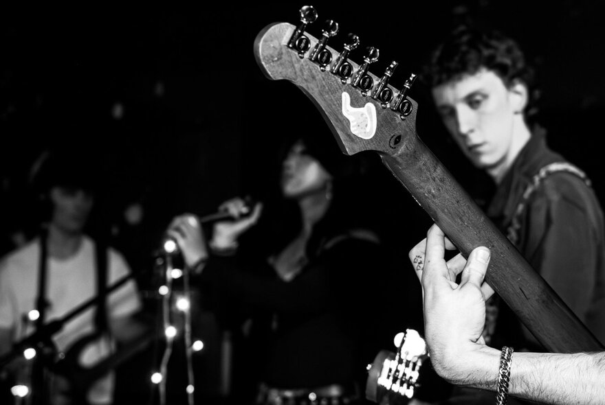 Black and white photograph of band members on stage.