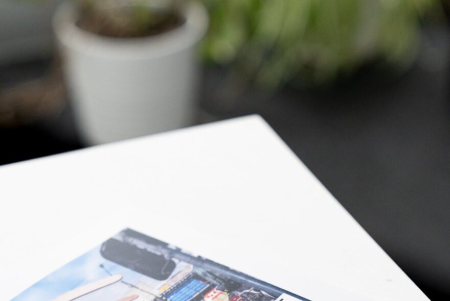 The edge of a photograph on the edge of a white table.