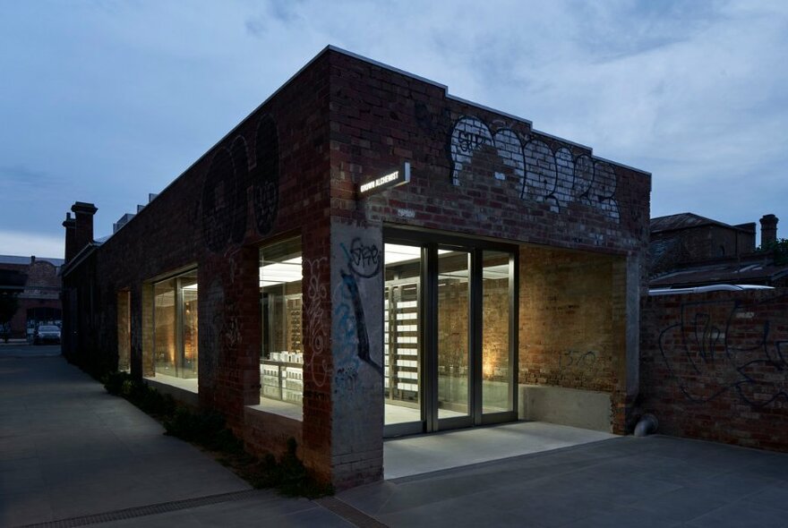 The exterior of a beauty store with graffiti-covered bricks.