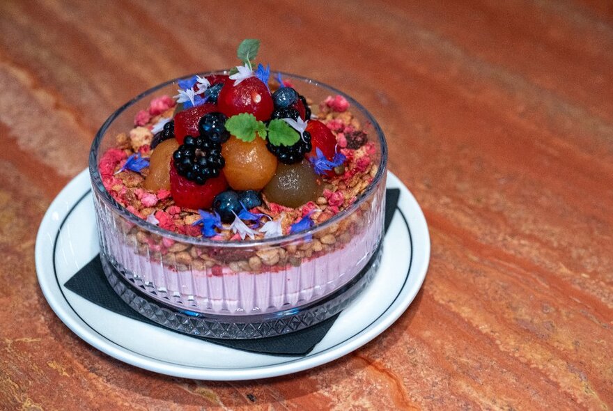 A colourful breakfast bowl with fruit and edible flowers. 