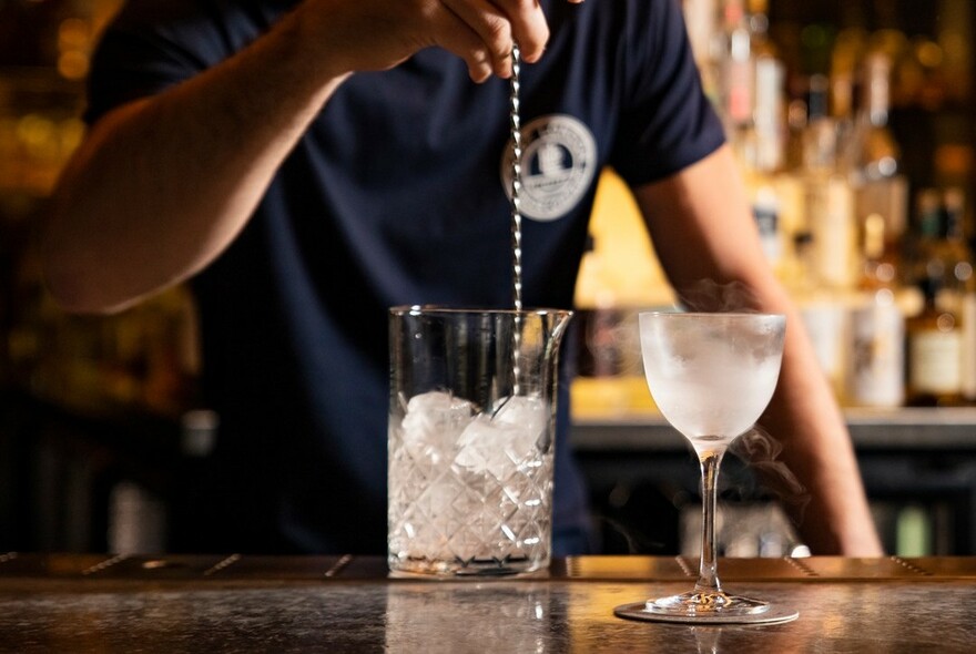 Cocktail being stirred on the bar.