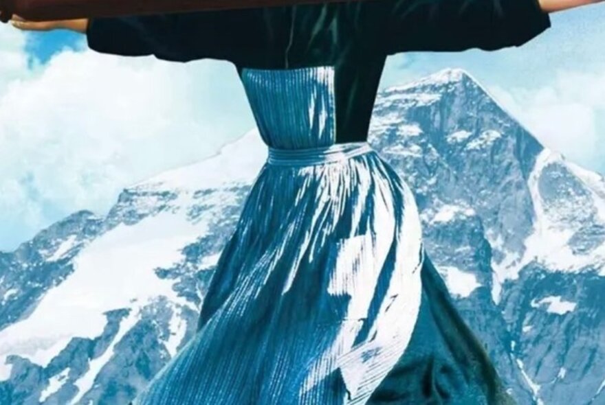 Image from The Sound of Music from shoulders down, woman with arms oustretched, wearing an apron, snowy mountain in the background.