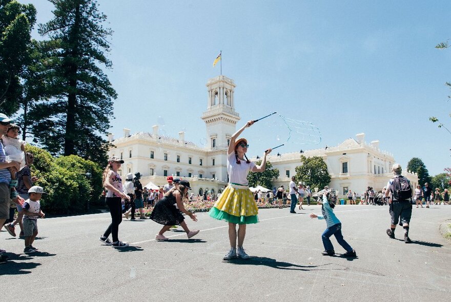Dancers and children performing on the forecourt at Government House.
