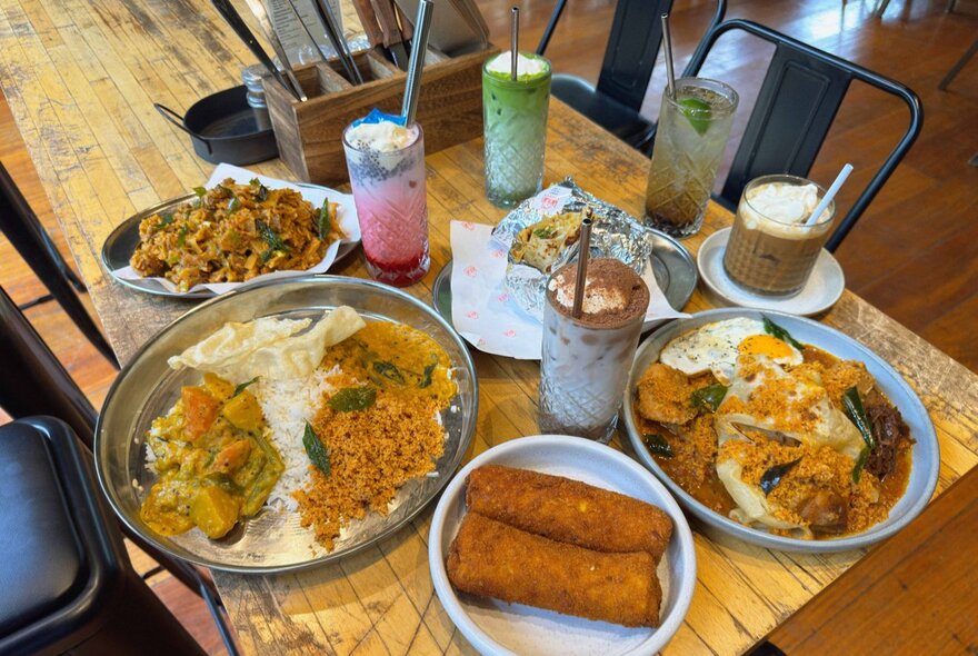 An assortment of Sri Lankan curries, sides and drinks.
