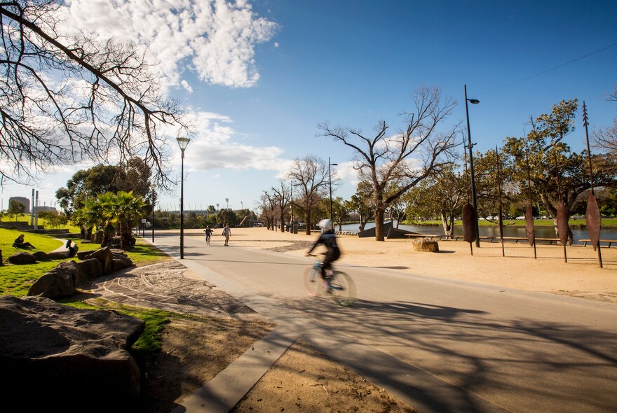 Person cycling in at Birrarung Marr park.