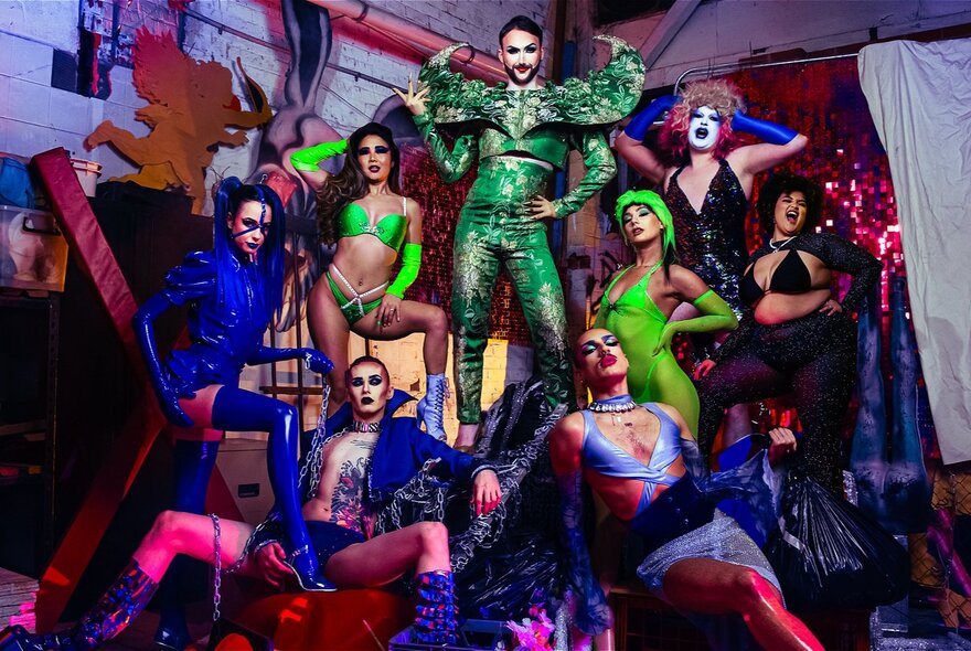 People dressed up for a Midsumma cabaret in coloured tight outfits, posing. 