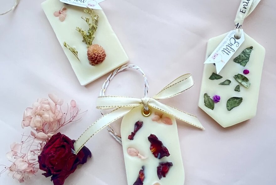 Various wax tags decorated with pressed flower petals.