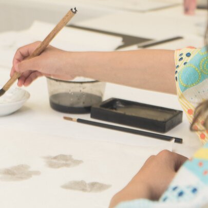 A person learning the art of Japanese water colour painting.