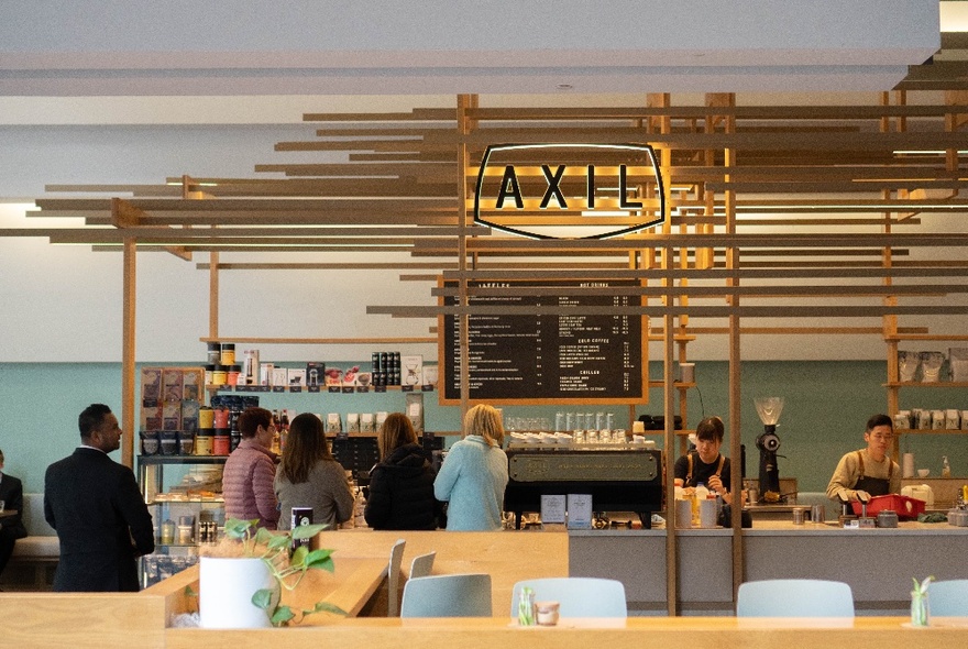 Interior of Axil Coffee Lonsdale St, with people ordering at a large service counter.