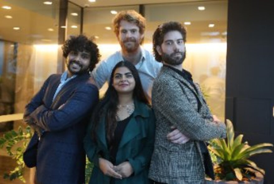 The four member cast of the play, posing and smiling.