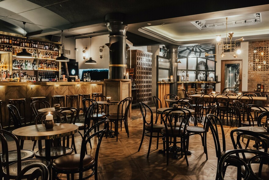 Basement cocktail bar with small tables.