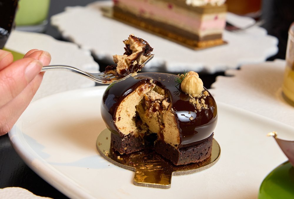 A small chocolate cake with a slice taken out. 