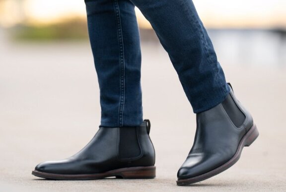 Male modelling elastic-sided boots with tight jeans.