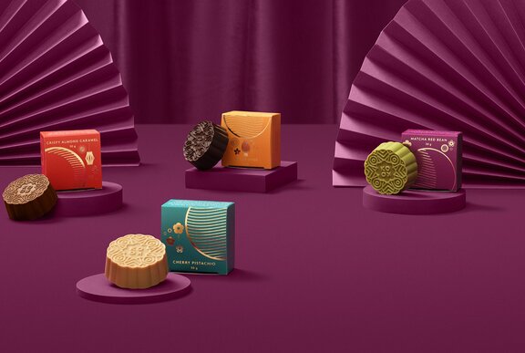 A selection of different flavoured moon cakes in colourful packaging.