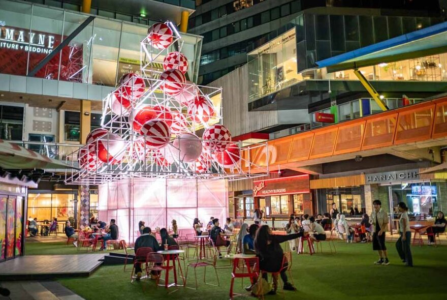 An experimental Christmas tree installation made out of pink and red baubles