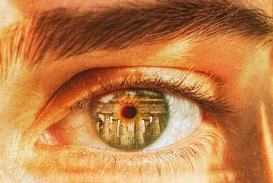 Eye close-up with reflection of ancient Greek temple.