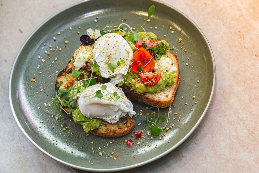 Poached eggs on smashed avocado toast.