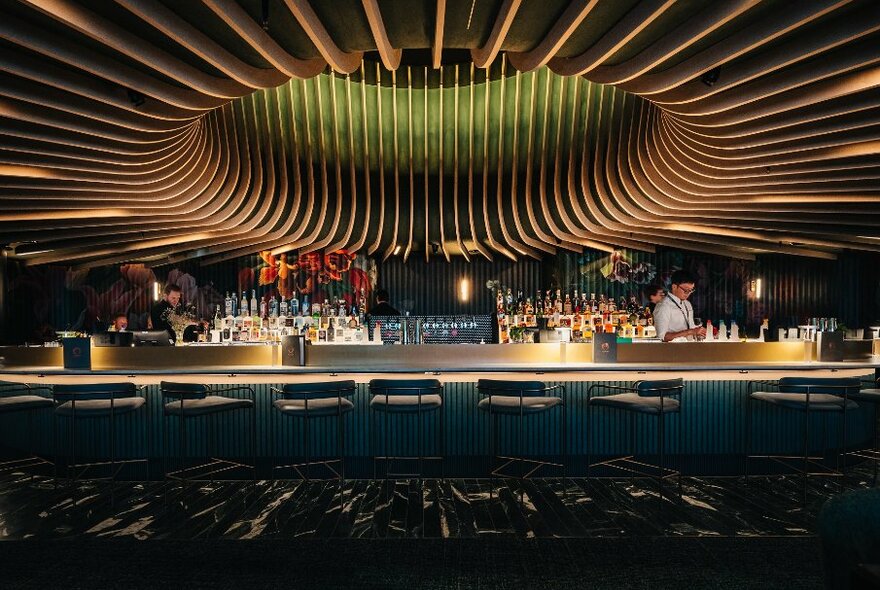 Dimly-lit modern bar with tall stools.