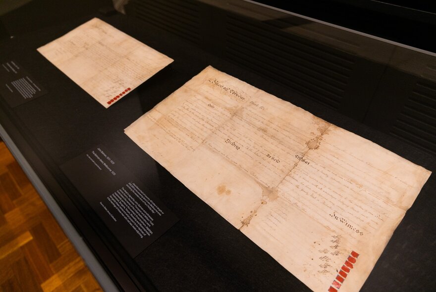 An exhibition at the State Library Victoria, specifically designed to display the original 1835 treaty documents, shown here under a glass display case.