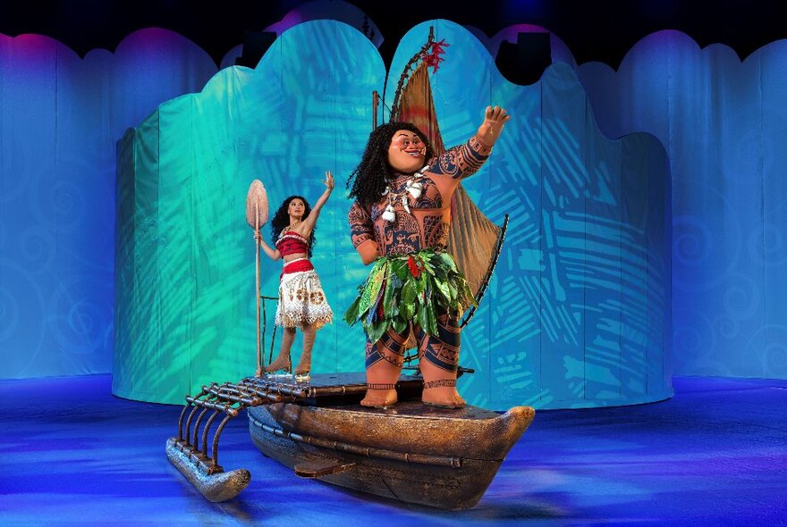 Moana and Maui sailing on a wooden outrigger canoe during Disney on Ice.