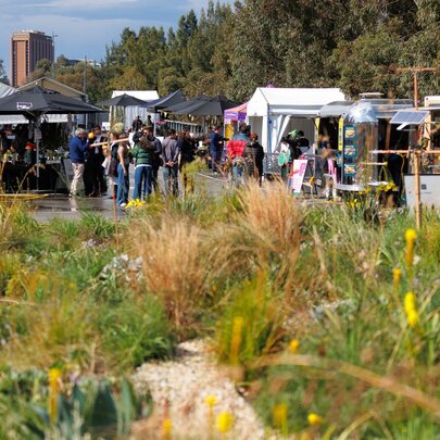 Rooftop garden at Fed Square with people under market umbrellas.