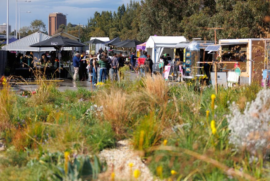 Rooftop garden at Fed Square with people under market umbrellas.