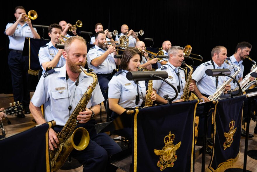 Royal Australian Air Force Big Band performing in uniform with military livery on their music stands. 
