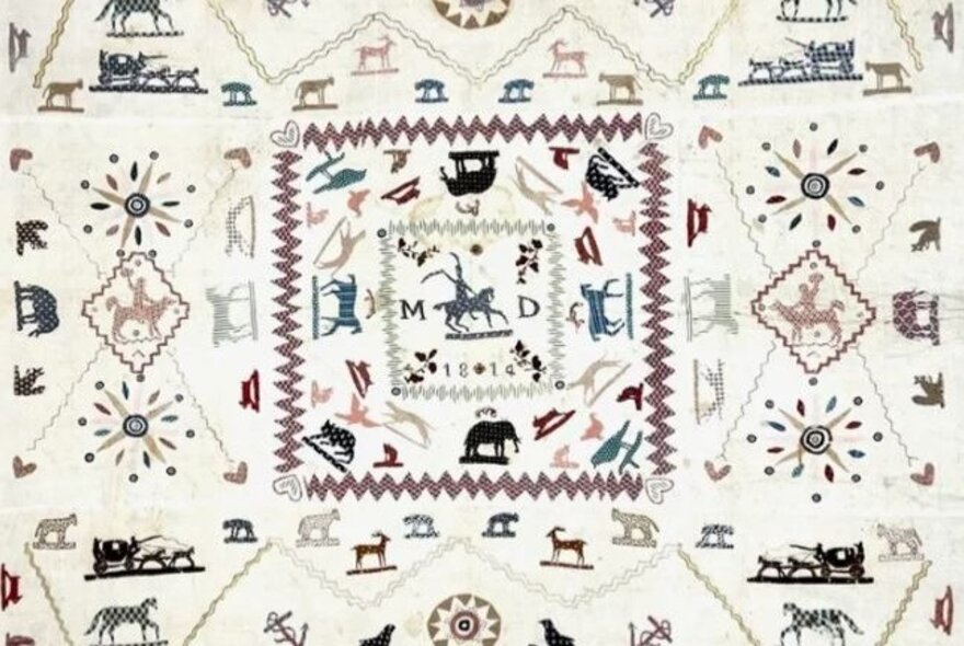Embroidered sampler with initials and animals.