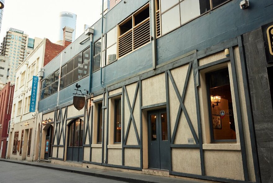 Bavarian-styled restaurant exterior with dark timber and lathe fachwerk facade on a Melbourne laneway.