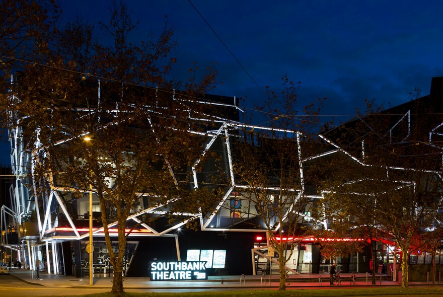 Striking geometric design of the Southbank Theatre, illuminated at night. 