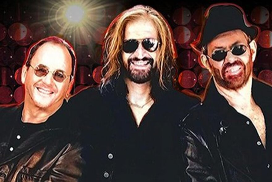 Glamourised portrait of the three key band members of the Bee Gees tribute band, BeeGees Revival, all wearing black clothes and dark glasses.