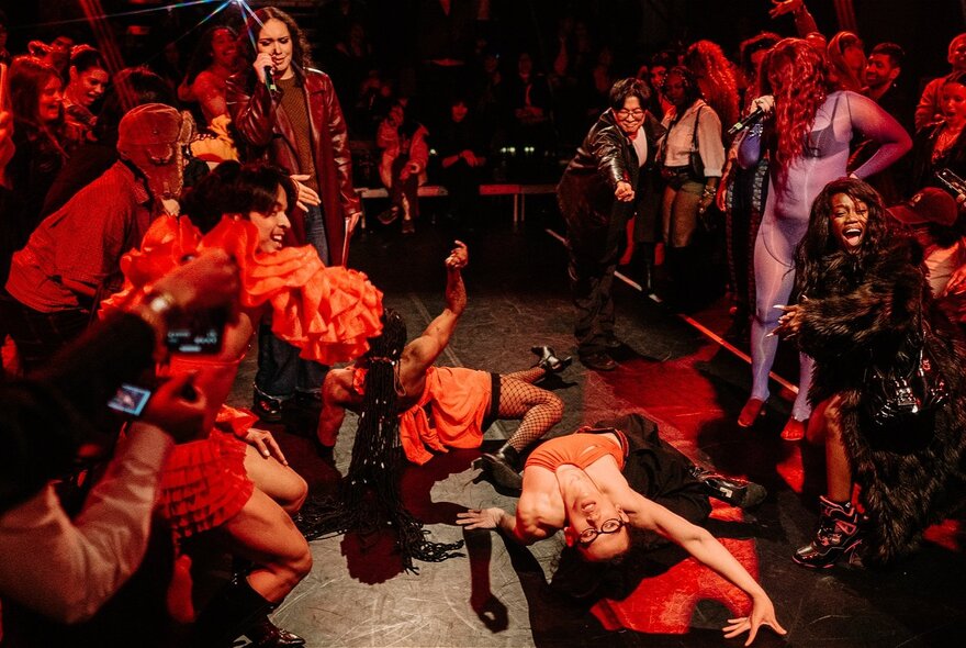 Looking from above at a group of people dancing with others looking on. 