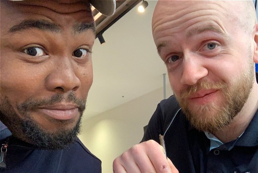 Two men looking bemused with raised eyebrows.