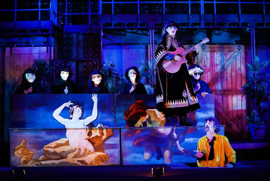 A stage production showing projected images of characters. 