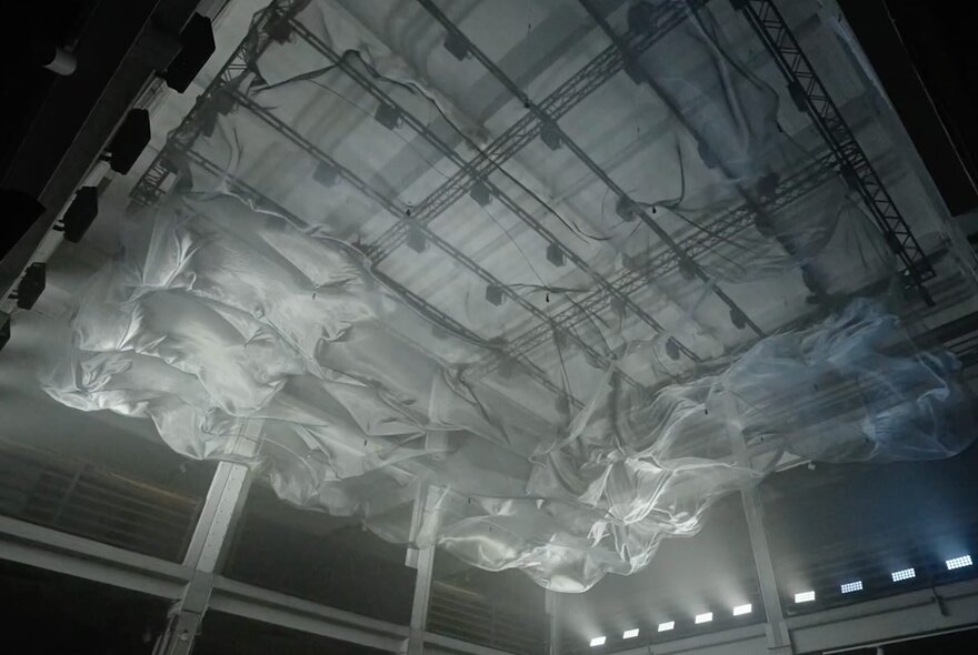 A floating installation of fabric hanging in the ceiling space at Melbourne Town Hall.