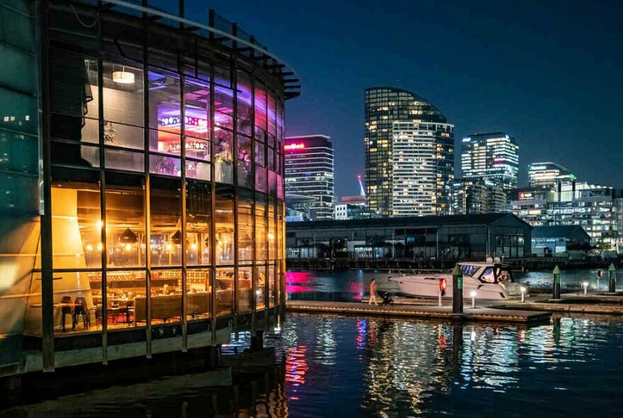 A restaurant at night overhanging the water