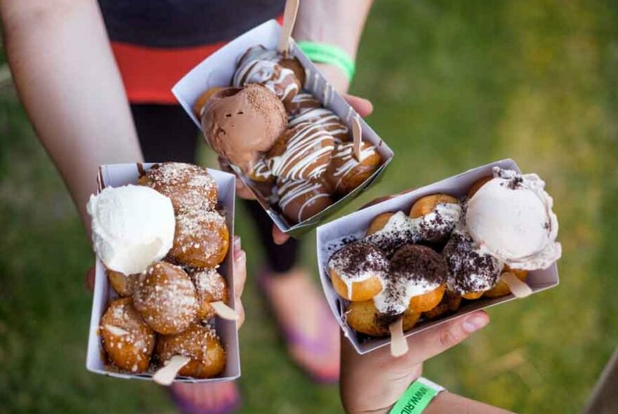 Three boxes filled with doughnuts