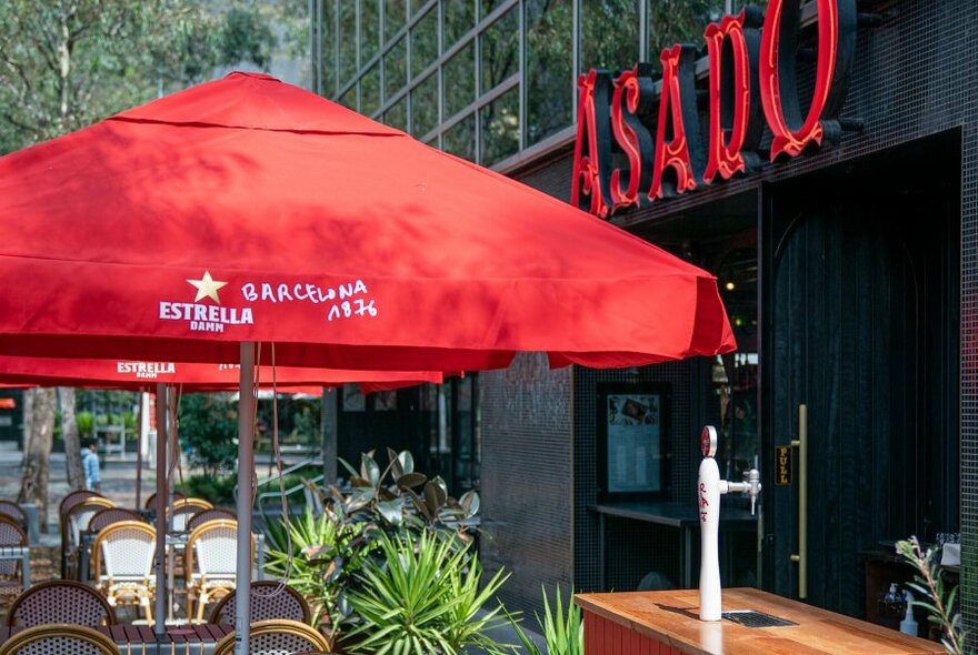 Red umbrella outside Asado restaurant.